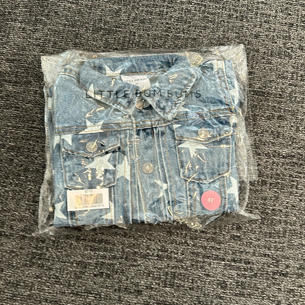 Brand new, still in package denim jacket with star pattern.  Size 4T